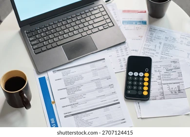 a calculator, laptop, and coffee mug—capturing that late-night 